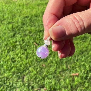 Silver Plated Handmade Pearly Iridescent Purple Drop Earrings video showing how the colors flash as the earrings move around in the light.
