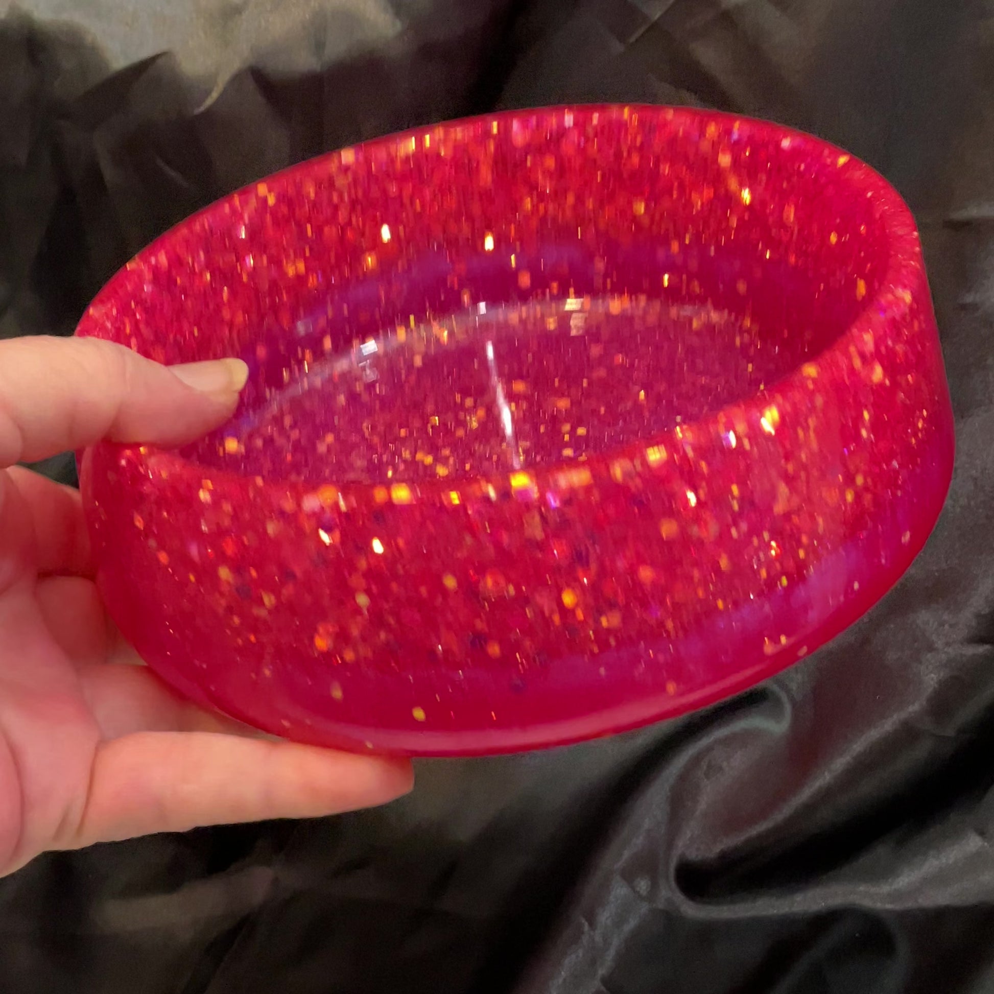 Video showing how the glitter in the handmade resin bowl sparkles in the light.