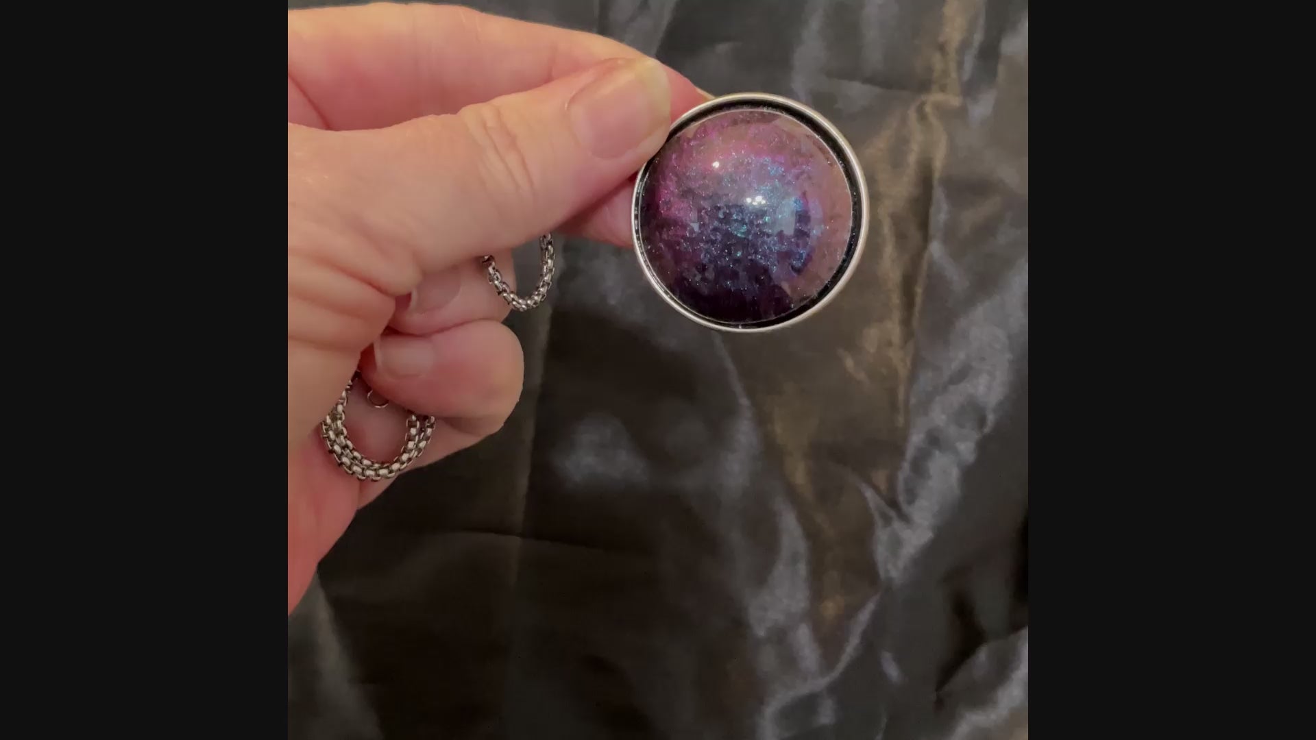 Video of the large blue and purple color shift domed round pendant showing how the colors change as the light hits it.