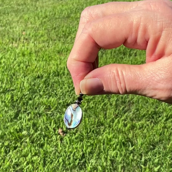 Abalone Handmade Drop Earrings video showing the flashes of color as it moves around in the light.