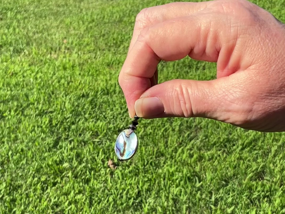 Abalone Handmade Drop Earrings video showing the flashes of color as it moves around in the light.