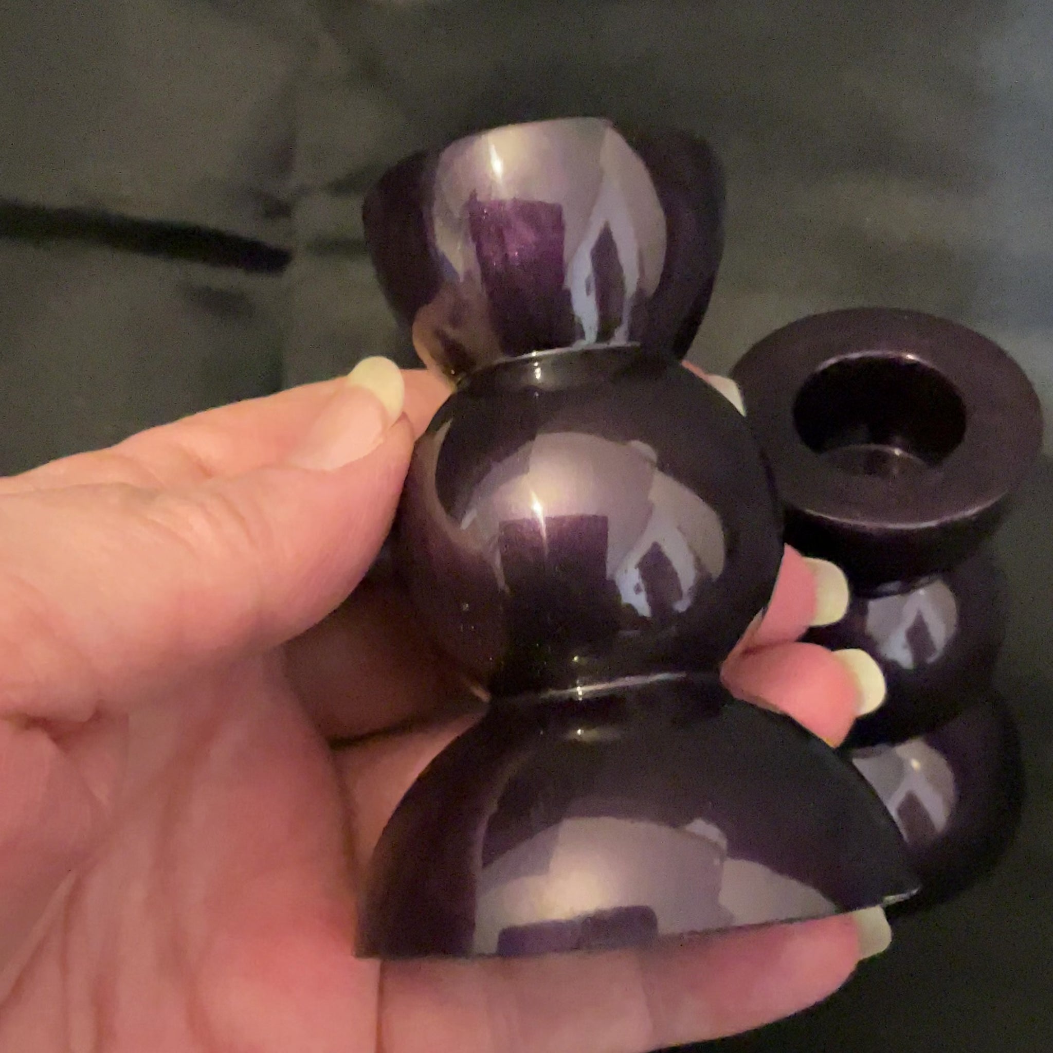 Handmade Pearly Deep Dark Purple Resin Rounded Geometric Goth Candlestick Holders video showing how there are flashes of dark purple as the light hits it.