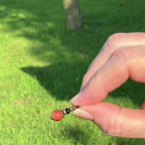 Small Round Handmade Goldstone Drop Earrings video showing how the sparkle in the light.