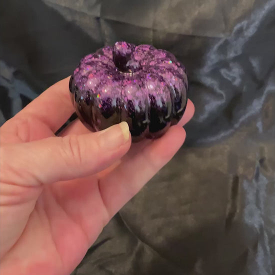 Video showing how the iridescent purple glitter sparkles as the light hits it.