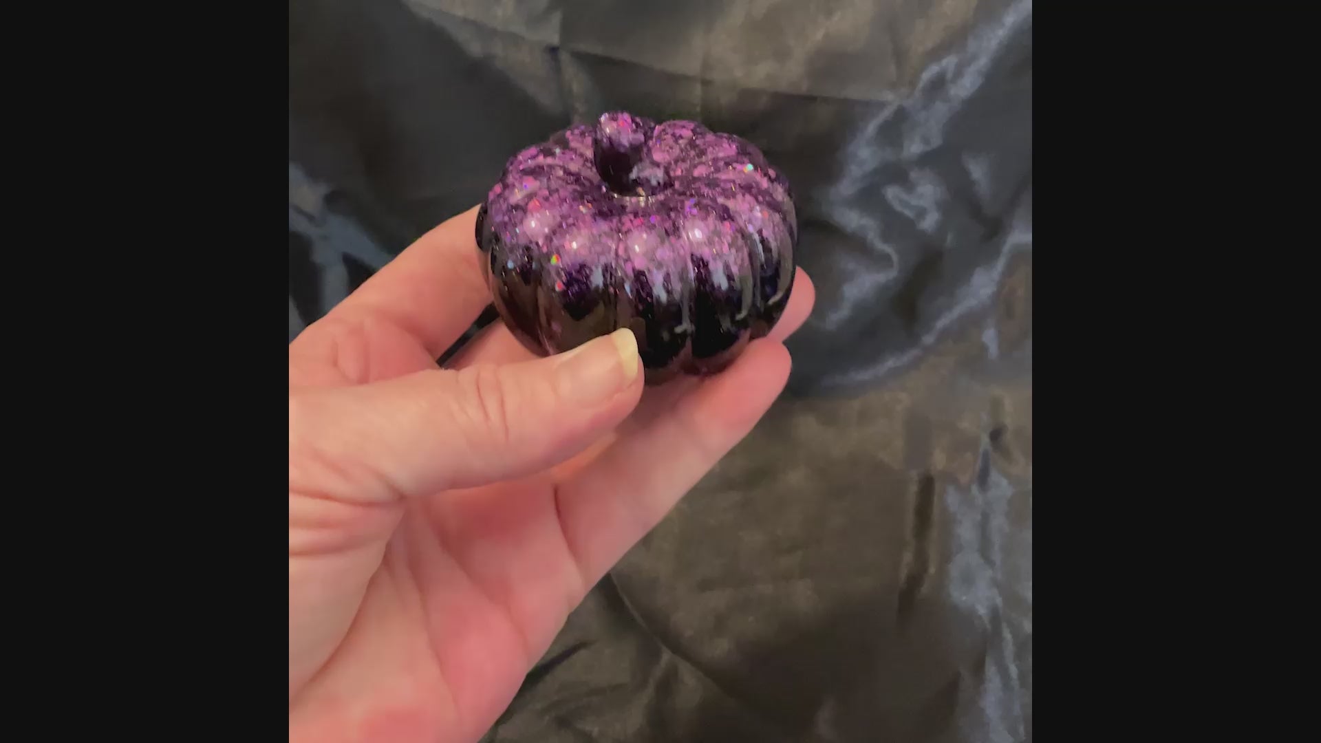 Video showing how the iridescent purple glitter sparkles as the light hits it.