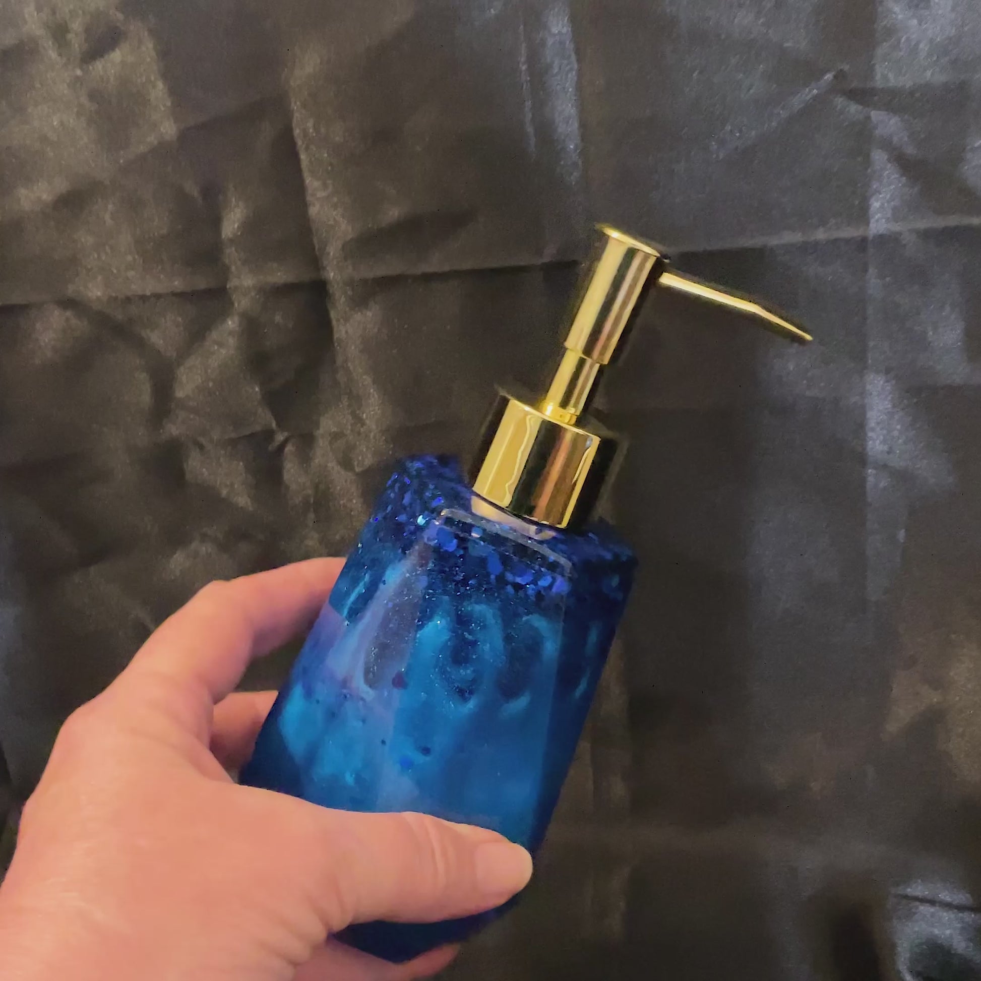 Video of the handmade dark ocean blue soap dispenser showing how the glitter sparkles in the light.