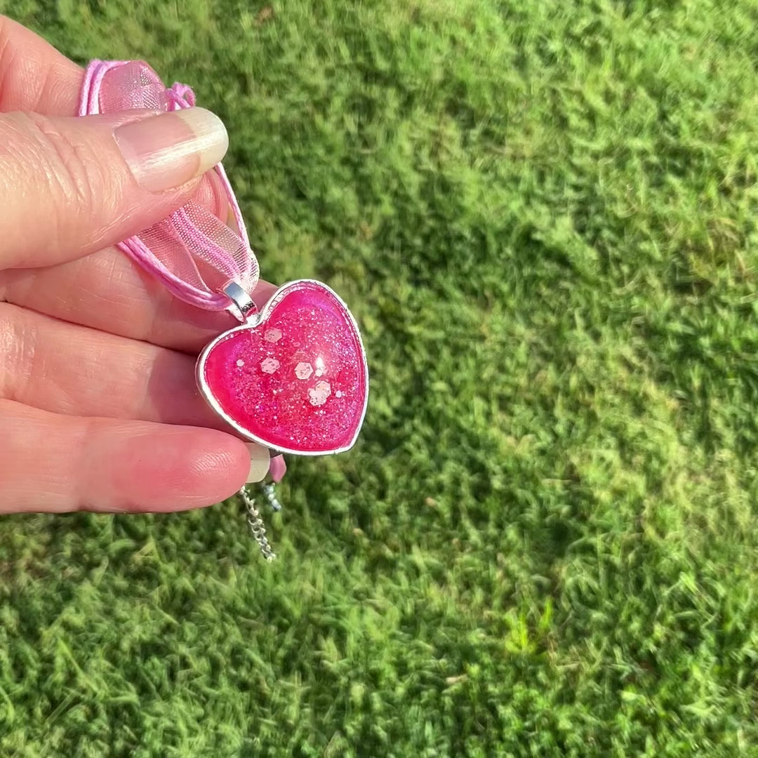 Handmade Pearly Bright Pink Resin Pendant Necklace with Iridescent Glitter video showing how the glitter sparkles and flashes in the light.