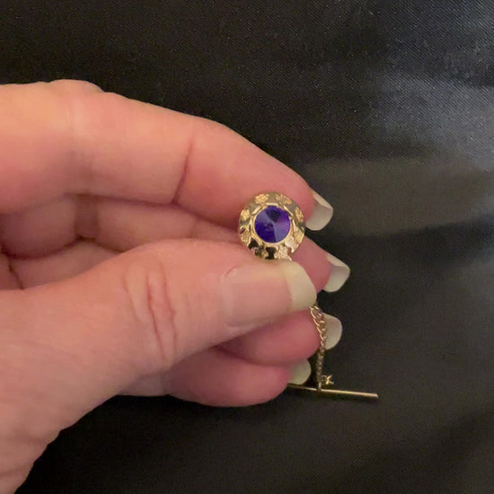 Video of the 1960's Mid Century vintage rivoli rhinestone tie tack showing how the colors sparkle and flash in the light.