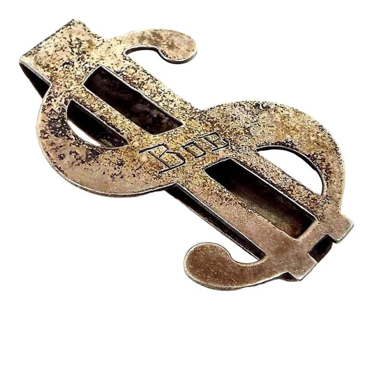 Front view of the Mid Century vintage dollar sign money clip. The sterling is darkened from age and has some pitting and blackened areas. The name Bob is engraved on the front.