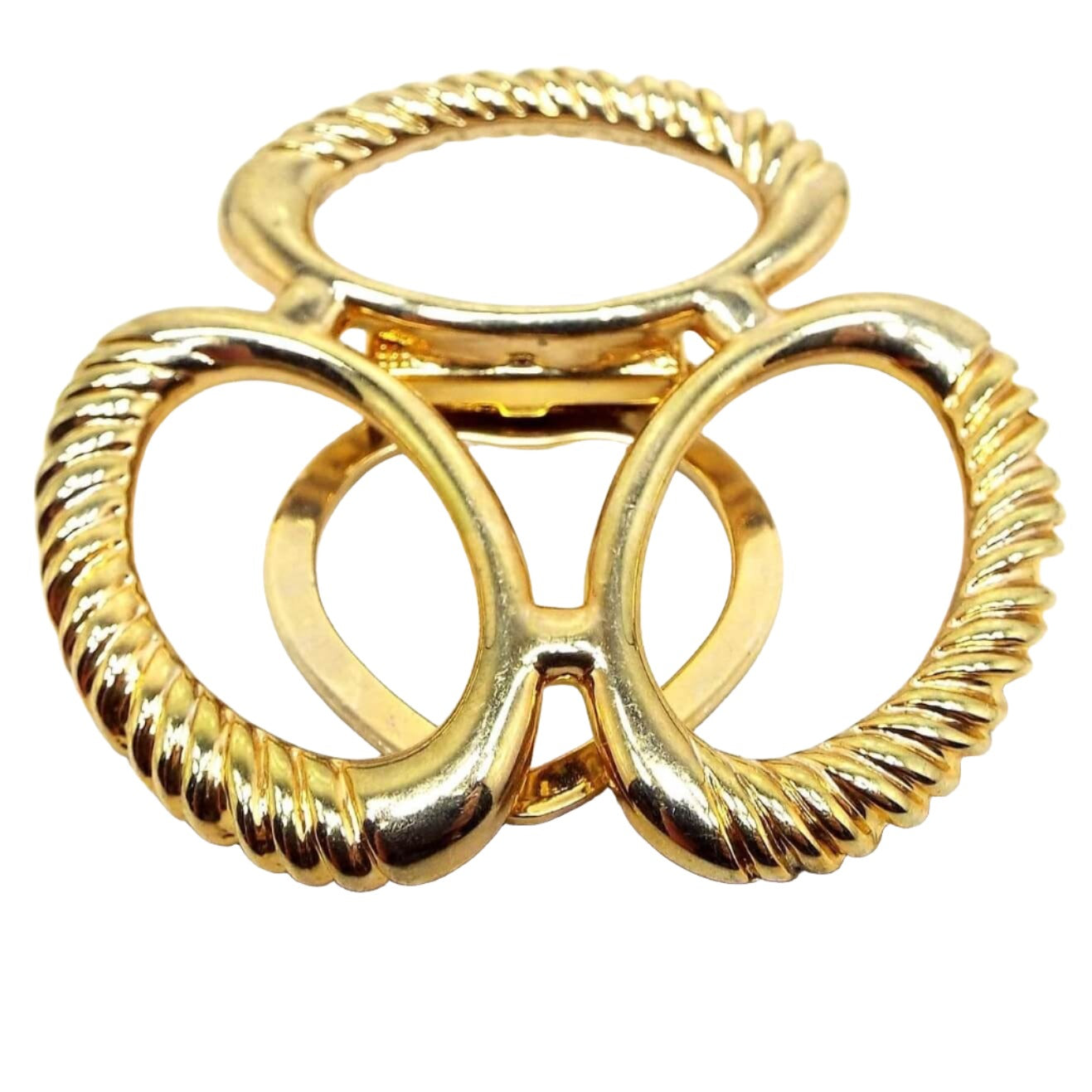 Front view of the large Mid Century vintage scarf clip. It is gold tone in color. There are three large ovals joined together in the middle. They have textured edges.
