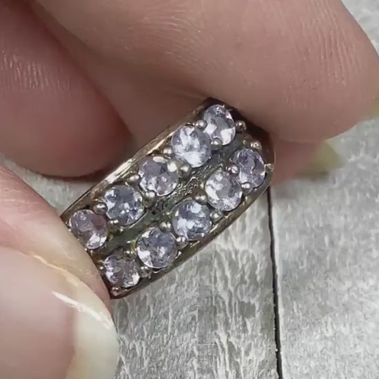 Video of the retro vintage cubic zirconia ring. The metal is sterling silver and there are two rows of CZ stones on the top of the band. The CZ stones are a light purple in color or a light blue depending on the lighting. The video shows them sparkle.