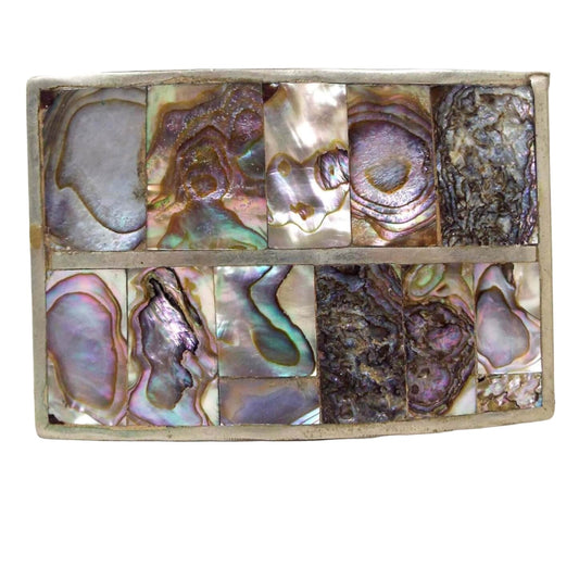 Front view of the retro vintage abalone belt buckle made in Mexico. It is rectangle in shape with silver tone color metal. There are rectangular pieces of abalone shell inlaid across two rows on the front.