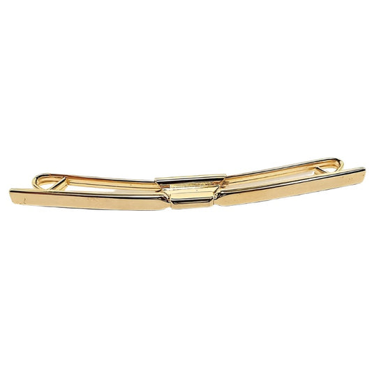 Front view of the Mid Century vintage long collar clip. It is gold tone in color with a flat curved bar on the front. 