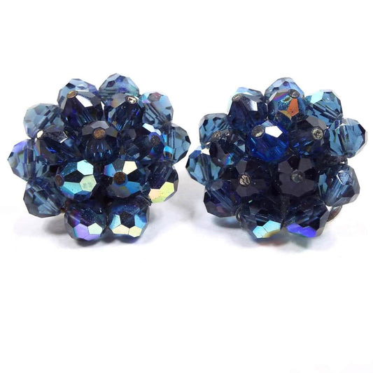 Front view of the Laguna Mid Century vintage cluster beaded clip on earrings. The glass crystal beads are blue and AB blue in color and are faceted round style. 