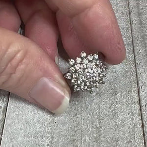 Video of the retro vintage sterling silver cubic zirconia cocktail ring. There is a large cluster of small round clear CZ stones at the top. The video is showing how they sparkle.