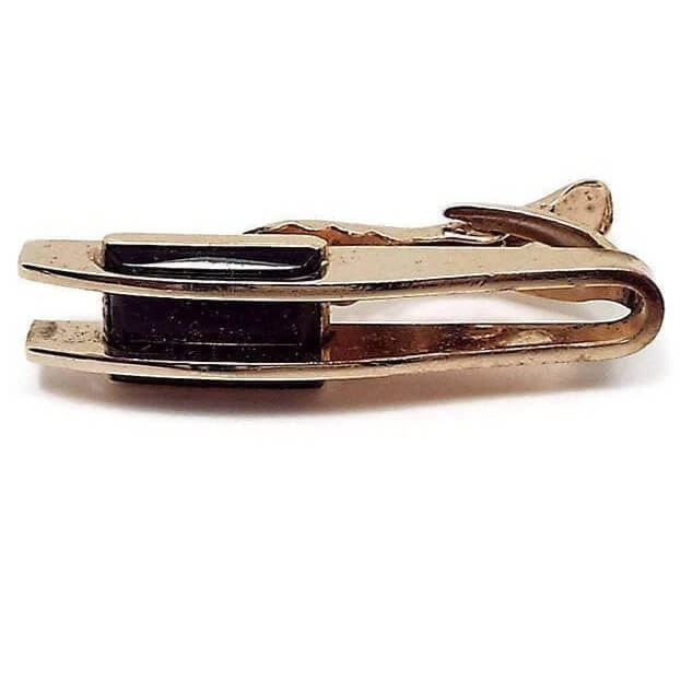 Front view of the Hickok Mid Century vintage tie clip. The metal is gold tone in color. There are two bars going horizontally with a black glass cab through the middle of them.