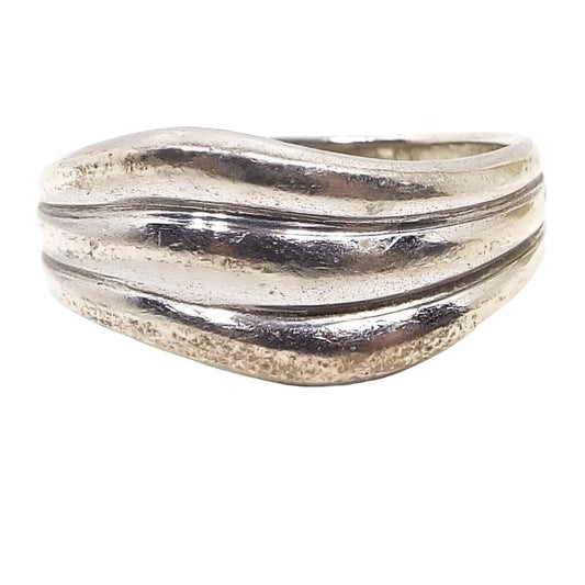 Front view of the sterling silver wavy band ring. It has three wavy stripe like areas on the front to the sides. 