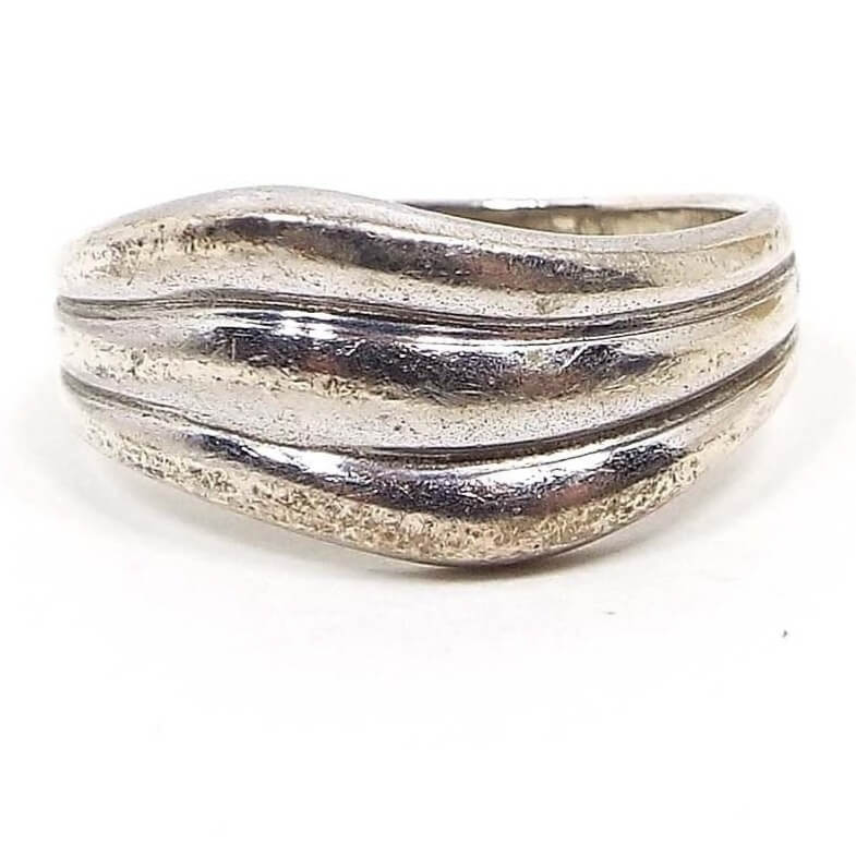 Front view of the sterling silver wavy band ring. It has three wavy stripe like areas on the front to the sides. 