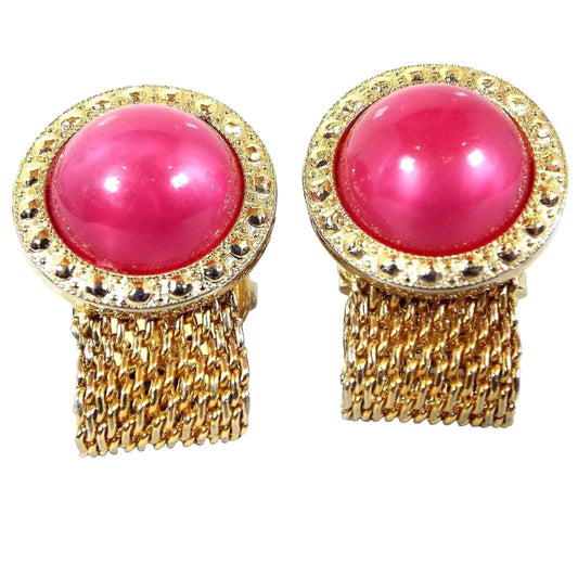 Front view of the Mid Century vintage Foster mesh wrap around cufflinks. They are gold tone in color and have round tops with bright pink moonglow lucite cabs. The cabs are pearly pink and have a glowy effect as you move around.