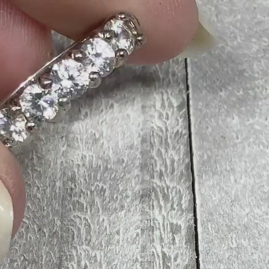 Video of the retro vintage sterling silver cubic zirconia ring. There are round clear CZ stones across the top of the band. The video shows how they sparkle. 