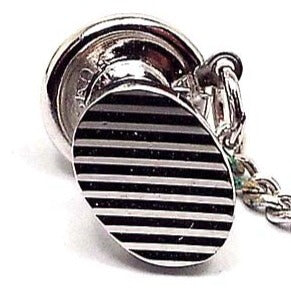 Front view of the retro vintage Hickok tie tack. It is silver tone in color. The front is oval with diagonal cut line design. Hickok is marked on the clutch back.
