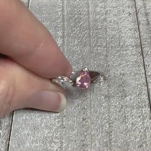 Video showing the sparkle on the cubic zirconia stones on the sterling silver retro vintage ring. There is a teardrop shaped pink CZ in the middle and clear marquis shaped CZ stones on each side of that. 