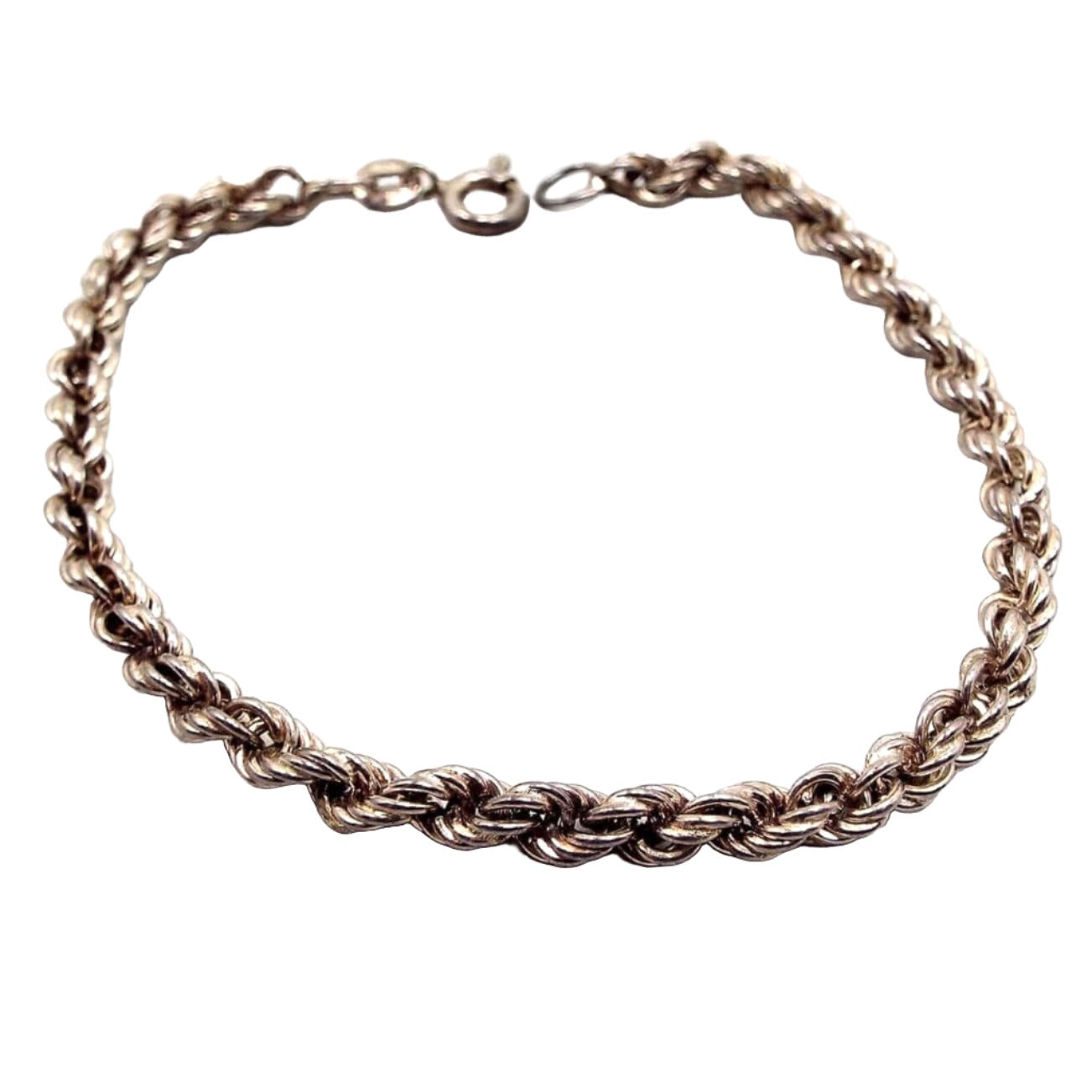 Angled view of the retro vintage Italian sterling silver chain bracelet. It is a darkened silver tone in color and has a twisted rope link design. There is a spring ring clasp at the end.