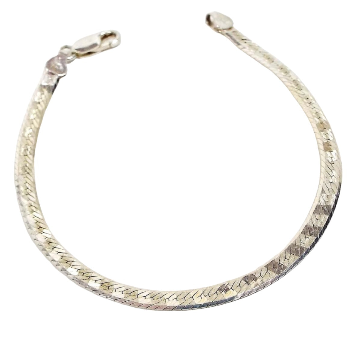 Top view of the retro vintage Italian sterling silver herringbone chain bracelet. The side showing has a diagonal pattern design on the links. It has a lobster claw clasp at the end.