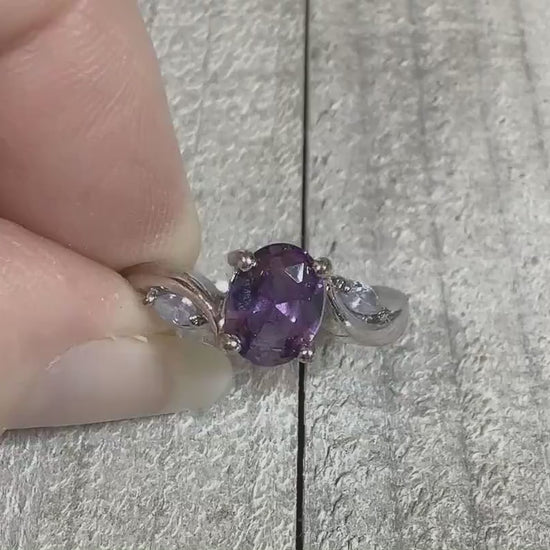 Video of the retro vintage rhinestone cocktail ring. The metal is silver tone in color. There is an oval purple rhinestone at the top with a marquis shaped clear rhinestone on each side of it. The video is showing how the rhinestones sparkle.
