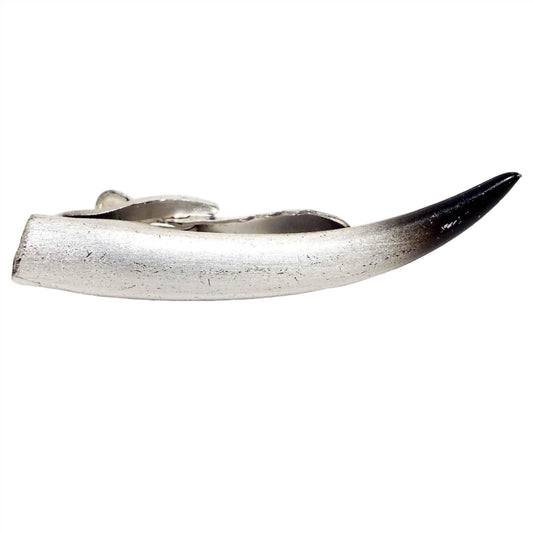 Front view of the retro vintage Hickok Western style tie clip. It's shaped like a steer horn with matte silver tone metal and black and gray shaded paint at the tip.