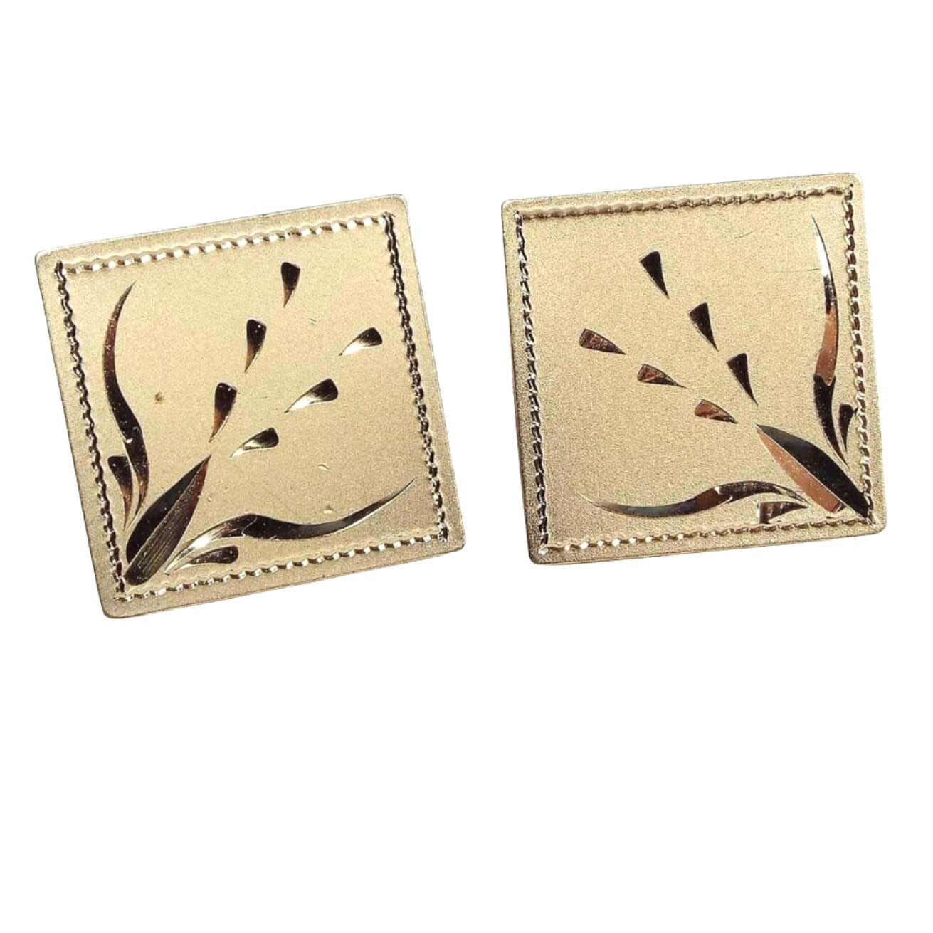 Front view of the Mid Century vintage Anson cufflinks with diamond cut etched design. The are matte gold tone in color and square in shape. There is a cut leaf style design going diagonally inward. 