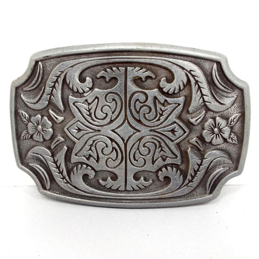 Front view of the retro vintage floral belt buckle. It is pewter gray in color and has a raised flower design on the front.