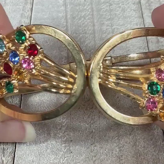Video showing the sparkle of the stones on the Mid Century vintage multi color rhinestone hinged bangle bracelet. The rhinestones are different colors of the rainbow.