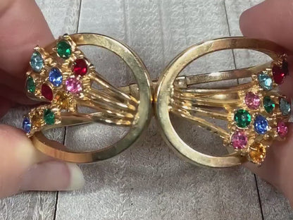 Video showing the sparkle of the stones on the Mid Century vintage multi color rhinestone hinged bangle bracelet. The rhinestones are different colors of the rainbow.
