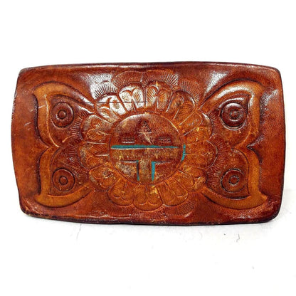 Front view of the retro vintage tooled leather belt buckle. It has a Boho Hippie style design of a butterfly and sunflower flower on the front. It is arranged so that it appears the flower has butterfly wings.