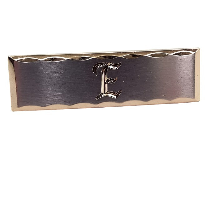 Front view of the Hickok Mid Century vintage initial tie clip. The edge is gold tone in color with a scalloped cut design. The middle part is silver tone in color with the letter E engraved on the front.