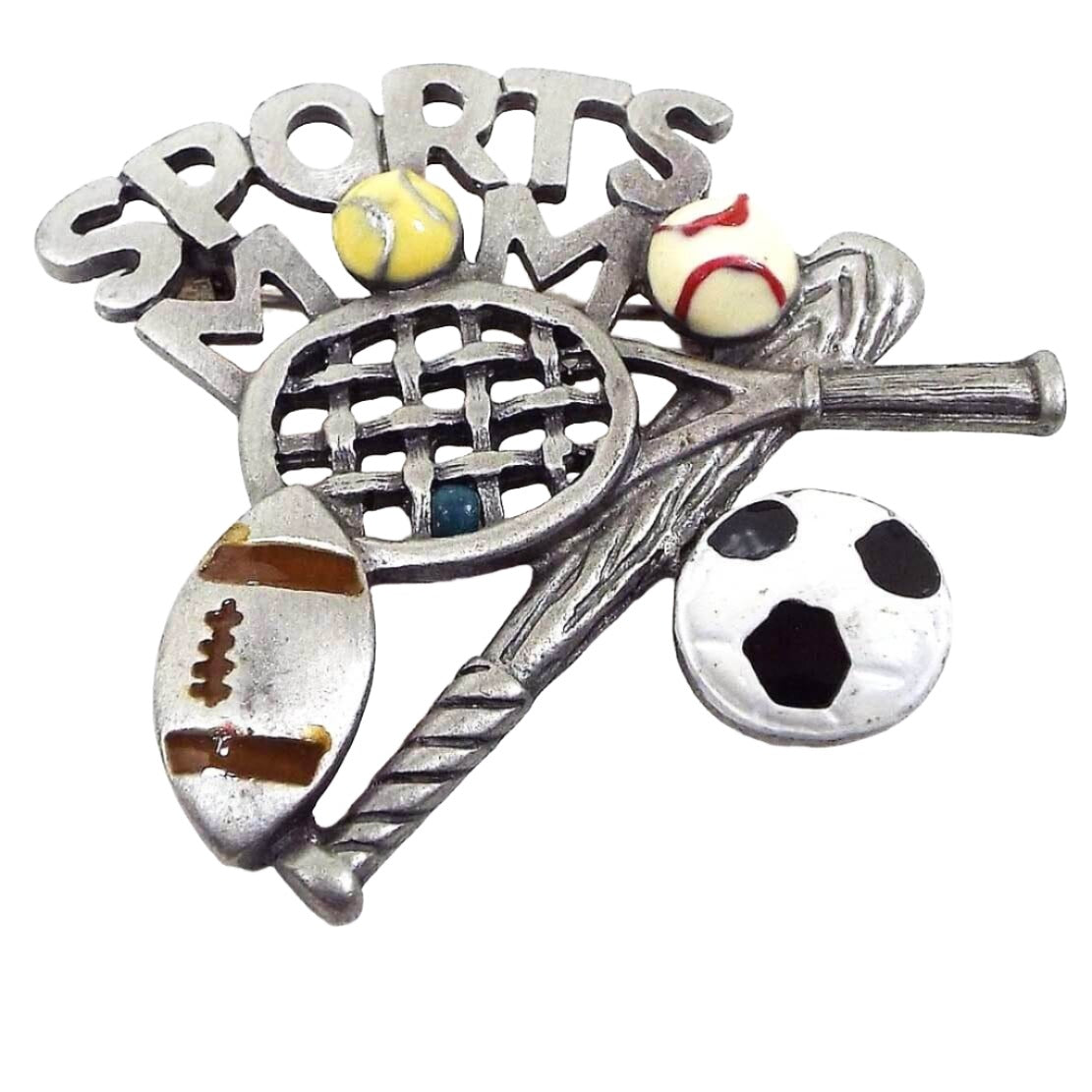 Front view of the retro vintage enameled Sports Mom brooch pin. It is pewter and has the words "Sports Mom" at the top with a tennis ball as the O in the word Mom. Below that are a tennis racket, baseball, football, baseball bat, and soccer ball. All of the balls on the brooch have enameled areas in colors correlating to the type of ball they are. 