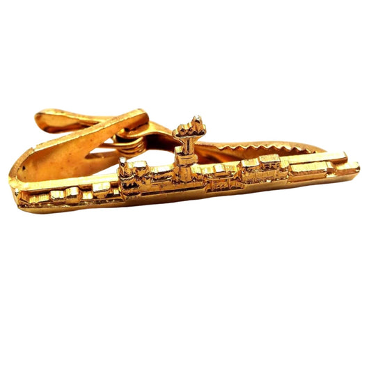 Front view of the retro vintage Hilborn Hamburger vintage tie clip. It is gold tone in color and is in the shape of a detailed Naval ship.