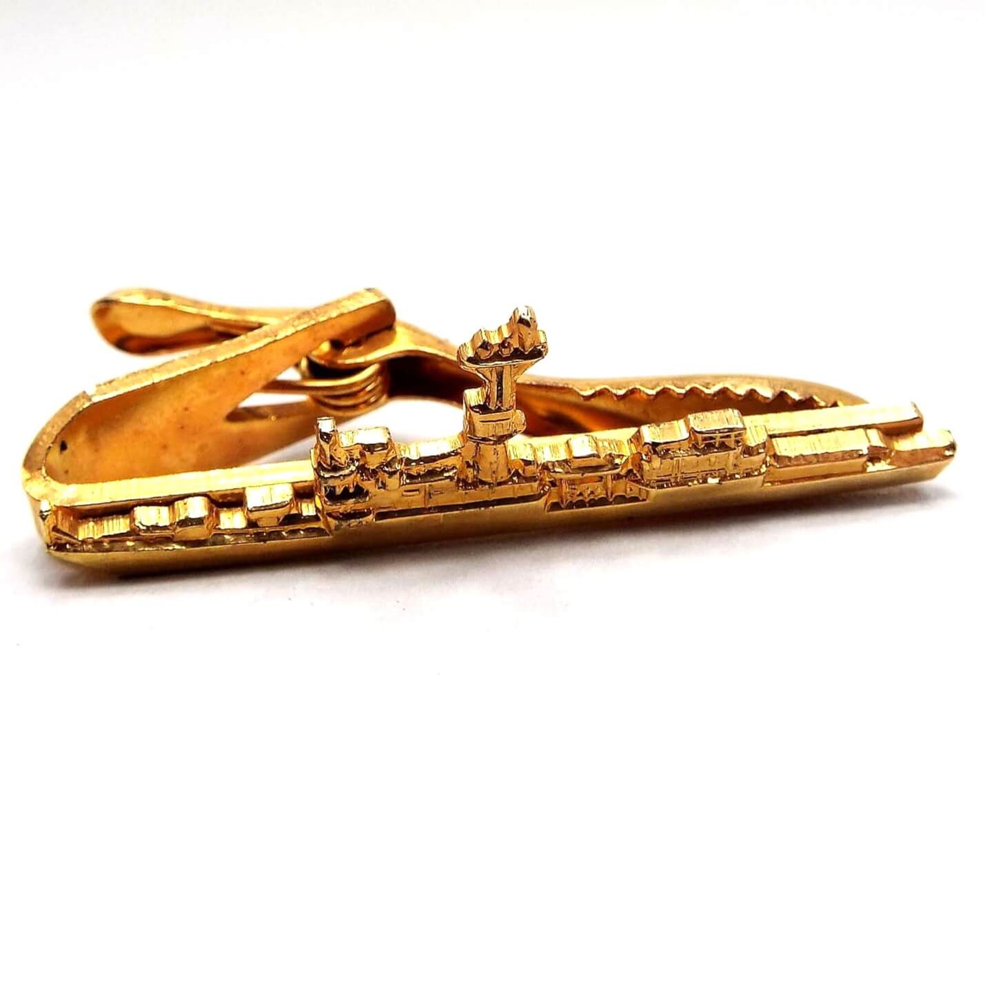 Front view of the retro vintage Hilborn Hamburger vintage tie clip. It is gold tone in color and is in the shape of a detailed Naval ship.