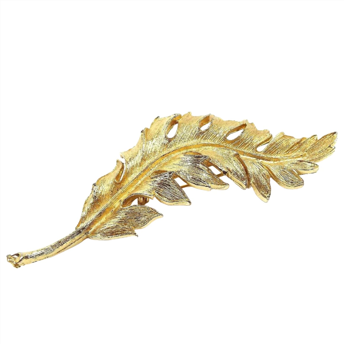 Front view of the 1961 Mid Century vintage Coro leaf brooch pin. It is shaped like a long leaf with stem and is nicely detailed in gold tone color metal. 