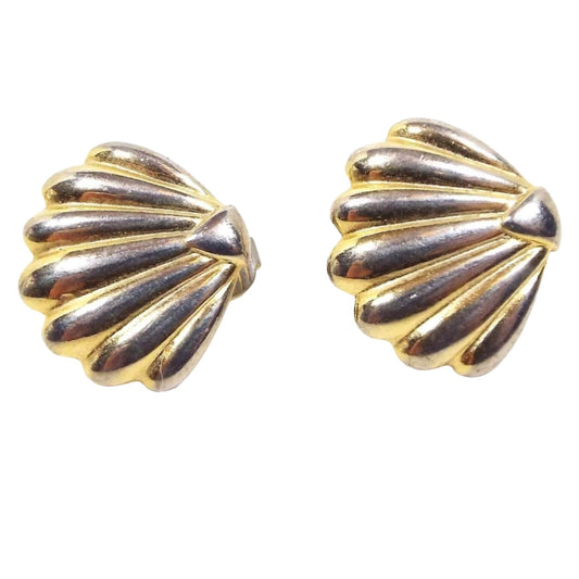 Front view of the retro vintage Direction One brand pierced earrings. They are gold tone in color and are corrugated shell shaped. 