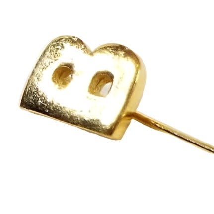 Enlarged view of the Mid Century vintage initial stick pin. The metal is gold tone in color and there is a small block style letter B at the top.