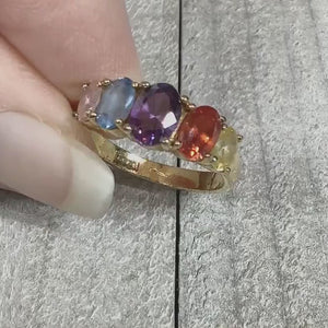 Video showing the sparkle of the multi color rainbow rhinestone ring. There are pink, blue, purple, orange, and yellow oval rhinestones at the top of the ring.