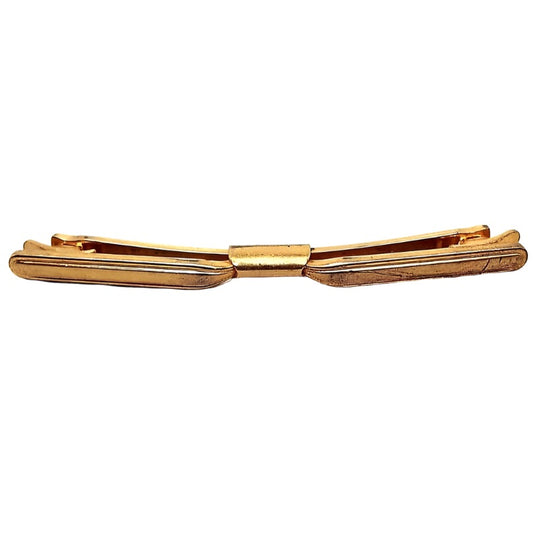 Front view of the Mid Century vintage curved collar clip. It is darkened gold tone in color and has some light scuff scratching on the right hand side.