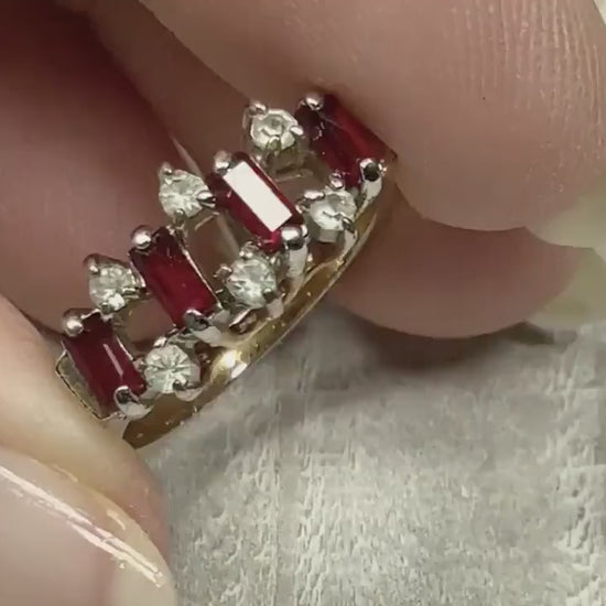 Video of the retro vintage rhinestone cocktail ring. The metal is gold tone. There are baguette red rhinestones with two small round clear rhinestones in between alternating across the top of the band. The video is showing how the rhinestones sparkle.