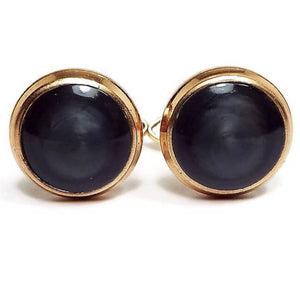 Front view of the Mid Century vintage bean back cufflinks. The fronts are larger round style with gold tone color metal. The fronts have pearly gray lucite plastic cabs.