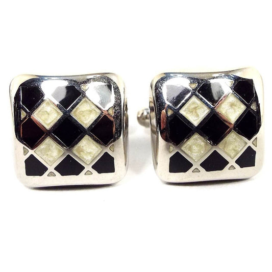 Front view of the retro vintage Italian cufflinks. They are rounded squares with silver tone color metal. There is an enameled diagonal checkerboard like pattern with black and pearly off white enamel.