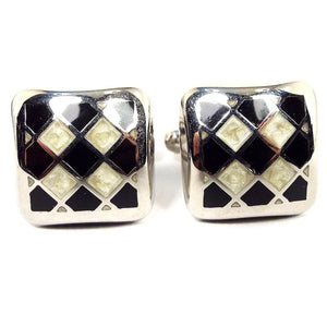 Front view of the retro vintage Italian cufflinks. They are rounded squares with silver tone color metal. There is an enameled diagonal checkerboard like pattern with black and pearly off white enamel.