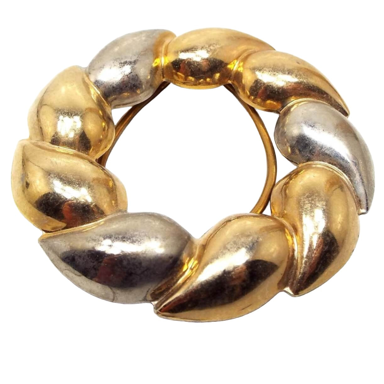Front view of the retro vintage scarf clip. It has a wreath like design with curved teardrops going around in an open circle. There are two antiqued gold tone teardrops and then an antiqued silver tone one as it goes around the clip.