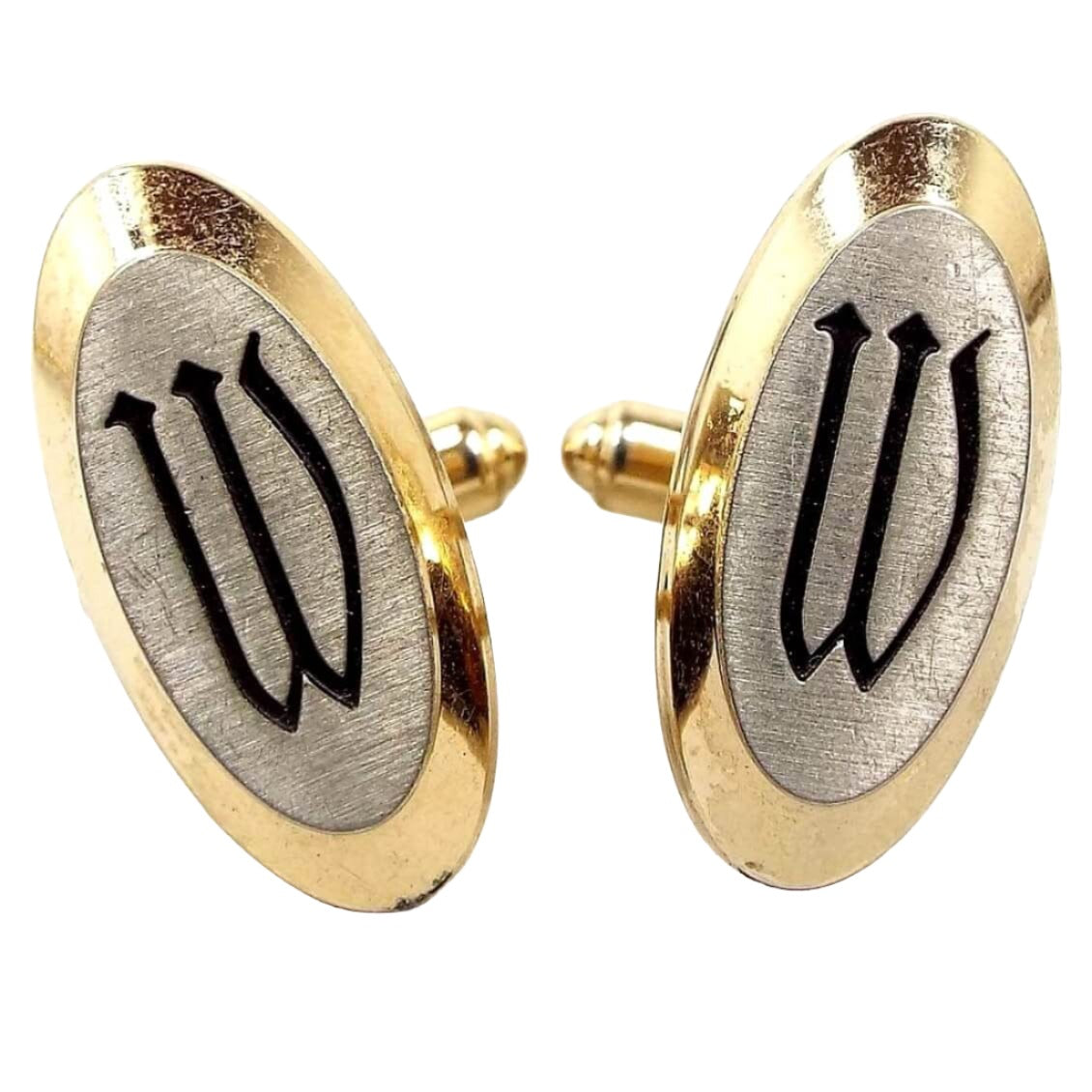 Front view of the Mid Century vintage Hickok initial cufflinks. They are mostly gold tone in color with matte silver tone color fronts. The letter W is engraved in black on the front.